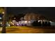 Outdoor restaurant seating area with umbrellas and customers in the evening at 1500 Sunset Rd # C7, Tarpon Springs, FL 34689