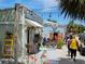 Charming vintage shops with floral displays and outdoor seating area at 1500 Sunset Rd # C7, Tarpon Springs, FL 34689