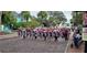 Festive street scene of Tarpon Springs with people holding shields and wearing Christmas hats at 1500 Sunset Rd # C7, Tarpon Springs, FL 34689