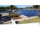 Scenic waterfront view featuring lush landscaping, serene water, and a decorative lamp post, enhancing curb appeal at 1500 Sunset Rd # C7, Tarpon Springs, FL 34689