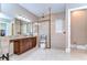Bathroom featuring dual vanities, glass shower, and neutral tones for a serene and spa-like experience at 15305 Fishhawk Preserve Dr, Lithia, FL 33547