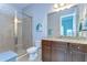 This bathroom features a glass shower, granite countertops, and a decorative turtle art piece at 15305 Fishhawk Preserve Dr, Lithia, FL 33547