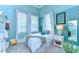 Bright bedroom with blue walls, white trim, and decorative accents at 15305 Fishhawk Preserve Dr, Lithia, FL 33547