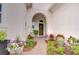 Charming front entrance with landscaped walkway leading to an arched doorway and decorated door at 15305 Fishhawk Preserve Dr, Lithia, FL 33547