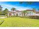 Beautiful single-story home showcasing a lush lawn, meticulous landscaping, and a tiled roof at 15305 Fishhawk Preserve Dr, Lithia, FL 33547