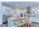 Gourmet kitchen featuring stainless steel appliances, granite countertops, a large island, and wicker chairs at 15305 Fishhawk Preserve Dr, Lithia, FL 33547
