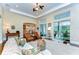 Open concept living room with hardwood floors, large windows offering pool views, and stylish furniture for gatherings at 15305 Fishhawk Preserve Dr, Lithia, FL 33547