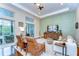 Cozy living room with sliding glass doors to the pool, hardwood floors, and comfortable seating for relaxation at 15305 Fishhawk Preserve Dr, Lithia, FL 33547