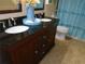 Bathroom vanity with dual sinks and dark wood cabinets at 15400 Gulf Blvd # 502, Madeira Beach, FL 33708