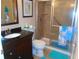 Bathroom featuring a stand-up shower with glass doors, vanity with a black countertop, and coastal decor at 15400 Gulf Blvd # 502, Madeira Beach, FL 33708