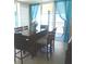 Cozy dining area with seating for six, bathed in natural light with sliders leading to the lanai at 15400 Gulf Blvd # 502, Madeira Beach, FL 33708