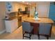 Kitchen with granite countertops, stainless steel appliances, breakfast bar with seating at 15400 Gulf Blvd # 502, Madeira Beach, FL 33708