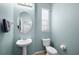 Powder bathroom with a pedestal sink, oval mirror, and tiled flooring at 16621 Kingletside Ct, Lithia, FL 33547