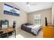 Bedroom with a ceiling fan and a large window providing plenty of natural light at 16621 Kingletside Ct, Lithia, FL 33547