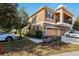 A beautiful multi-story home with a two-car garage and a well-maintained lawn with mature trees and shrubs at 16621 Kingletside Ct, Lithia, FL 33547
