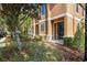 Exterior view of a townhome, showing patio, walkway, and landscaping at 16621 Kingletside Ct, Lithia, FL 33547