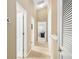 Hallway with carpeted floors and several doors leading to different rooms at 16621 Kingletside Ct, Lithia, FL 33547