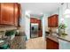 Well-equipped kitchen with stainless steel appliances, granite countertops, and ample cabinet space at 16621 Kingletside Ct, Lithia, FL 33547