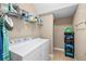 Laundry room with washer, dryer, shelving, and tile flooring at 16621 Kingletside Ct, Lithia, FL 33547