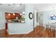 Open-concept living area that flows into the kitchen and dining area with hardwood floors at 16621 Kingletside Ct, Lithia, FL 33547