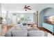 Open-concept living room featuring hardwood floors, views of the dining area, and serene color palette at 16621 Kingletside Ct, Lithia, FL 33547