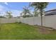 Well maintained backyard with vibrant green grass, white fence, and a garden area at 19926 Stone Pine Cir, Lutz, FL 33558