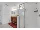 Bright bathroom featuring a walk-in shower, granite counters, and wood cabinetry at 19926 Stone Pine Cir, Lutz, FL 33558