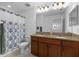 Bright bathroom features a double sink vanity, granite countertops, and a shower with modern fixtures at 19926 Stone Pine Cir, Lutz, FL 33558