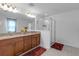 Bright bathroom features a double sink vanity, granite countertops, and a glass enclosed shower at 19926 Stone Pine Cir, Lutz, FL 33558