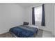 Bedroom with a cozy bed, soft carpet, and a window with privacy curtains at 19926 Stone Pine Cir, Lutz, FL 33558