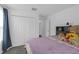 Cozy bedroom featuring a comfortable bed, soft carpet, closet, and neutral colors at 19926 Stone Pine Cir, Lutz, FL 33558