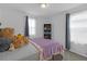 Cozy bedroom featuring a comfortable bed, soft natural light and a bookshelf at 19926 Stone Pine Cir, Lutz, FL 33558