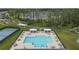 A community pool and lounge area are surrounded by landscaped grounds and towering trees at 19926 Stone Pine Cir, Lutz, FL 33558