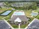 An aerial view of the community amenities featuring a large pool, clubhouse, and lake backdrop at 19926 Stone Pine Cir, Lutz, FL 33558