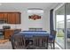 Dining area featuring modern chandelier and sliding glass doors for natural light at 19926 Stone Pine Cir, Lutz, FL 33558