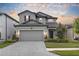 Beautiful two-story home featuring a paved driveway, two car garage and manicured front yard at 19926 Stone Pine Cir, Lutz, FL 33558