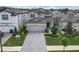 Exterior elevation of a modern two-story home with a paved driveway and landscaped front yard at 19926 Stone Pine Cir, Lutz, FL 33558