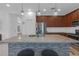 A modern kitchen island, adorned with granite countertops and elegant pendant lighting at 19926 Stone Pine Cir, Lutz, FL 33558