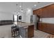 Modern kitchen island with stone accents, granite countertops, and bar stool seating at 19926 Stone Pine Cir, Lutz, FL 33558