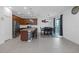 Open-concept kitchen and dining area featuring granite countertops, stainless appliances, and an island at 19926 Stone Pine Cir, Lutz, FL 33558