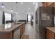 Kitchen featuring a center island with a granite countertop, stainless steel appliances, and an open layout at 19926 Stone Pine Cir, Lutz, FL 33558