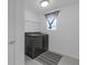 Bright laundry room features newer front loading washer and dryer, neutral colors, and practical shelving at 19926 Stone Pine Cir, Lutz, FL 33558