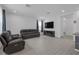 Spacious living room with hardwood floors, and a brown leather recliner and sofa set at 19926 Stone Pine Cir, Lutz, FL 33558