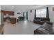 Open-concept living room with kitchen, dining area and sliding glass doors to backyard at 19926 Stone Pine Cir, Lutz, FL 33558