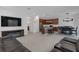 Open-concept living room and kitchen with a kitchen island and dark wooden cabinetry at 19926 Stone Pine Cir, Lutz, FL 33558