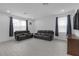 Bright living room featuring two leather couches and neutral flooring, perfect for relaxation at 19926 Stone Pine Cir, Lutz, FL 33558