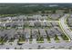 Aerial view of a residential neighborhood with neatly arranged homes and a serene lake backdrop at 19926 Stone Pine Cir, Lutz, FL 33558
