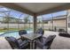 Covered patio featuring a table and chairs and view of screened pool at 19926 Stone Pine Cir, Lutz, FL 33558