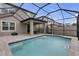 Relaxing screened-in pool area with patio, outdoor dining, and a beautiful blue swimming pool at 19926 Stone Pine Cir, Lutz, FL 33558