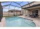 Screened in pool with outdoor seating area and stepping stones for easy access at 19926 Stone Pine Cir, Lutz, FL 33558